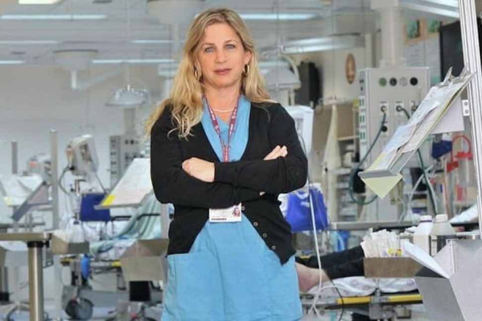 Nurse in front of medical equipment