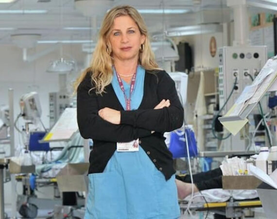 Nurse in front of medical equipment